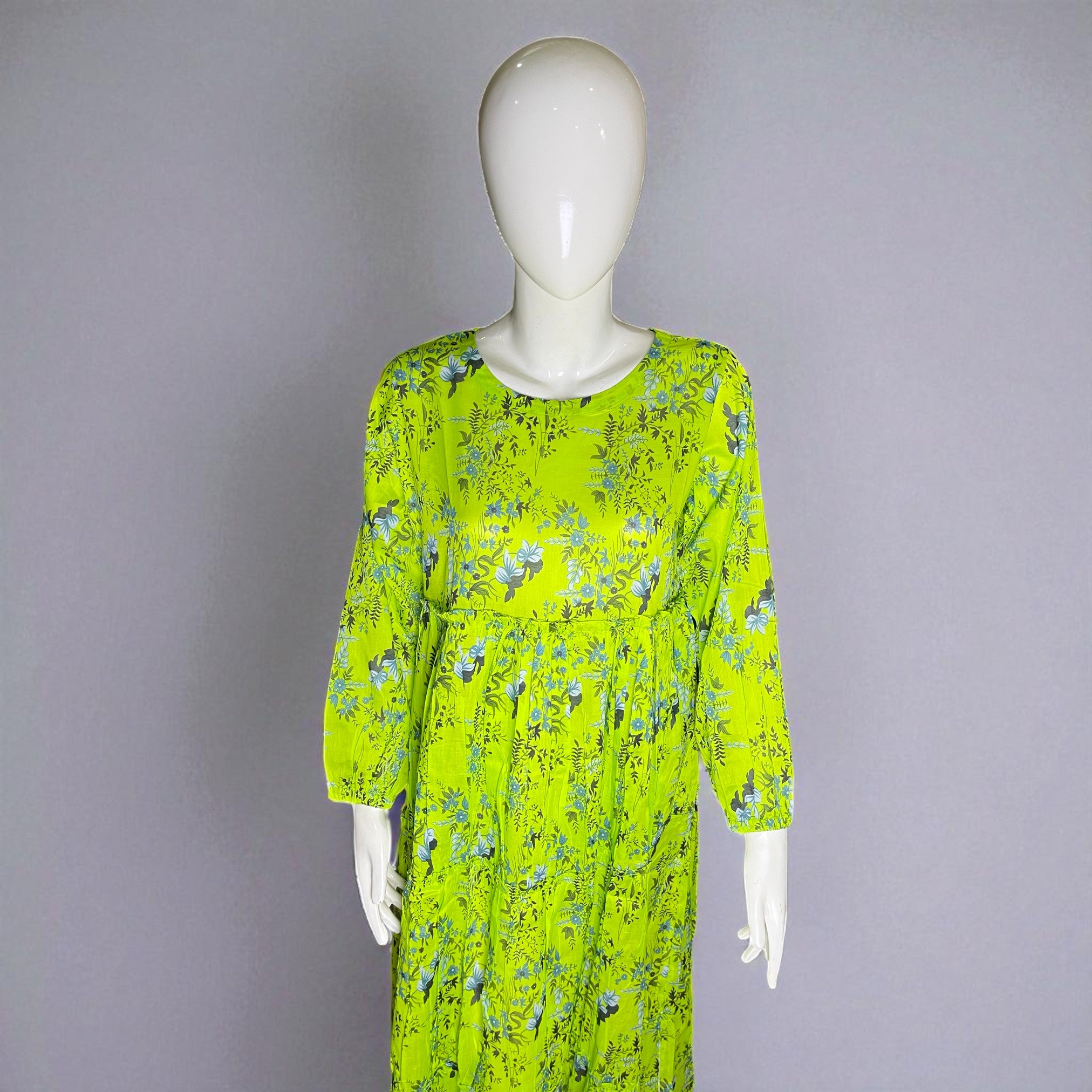 Mannequin wearing a bright green floral dress against a gray background