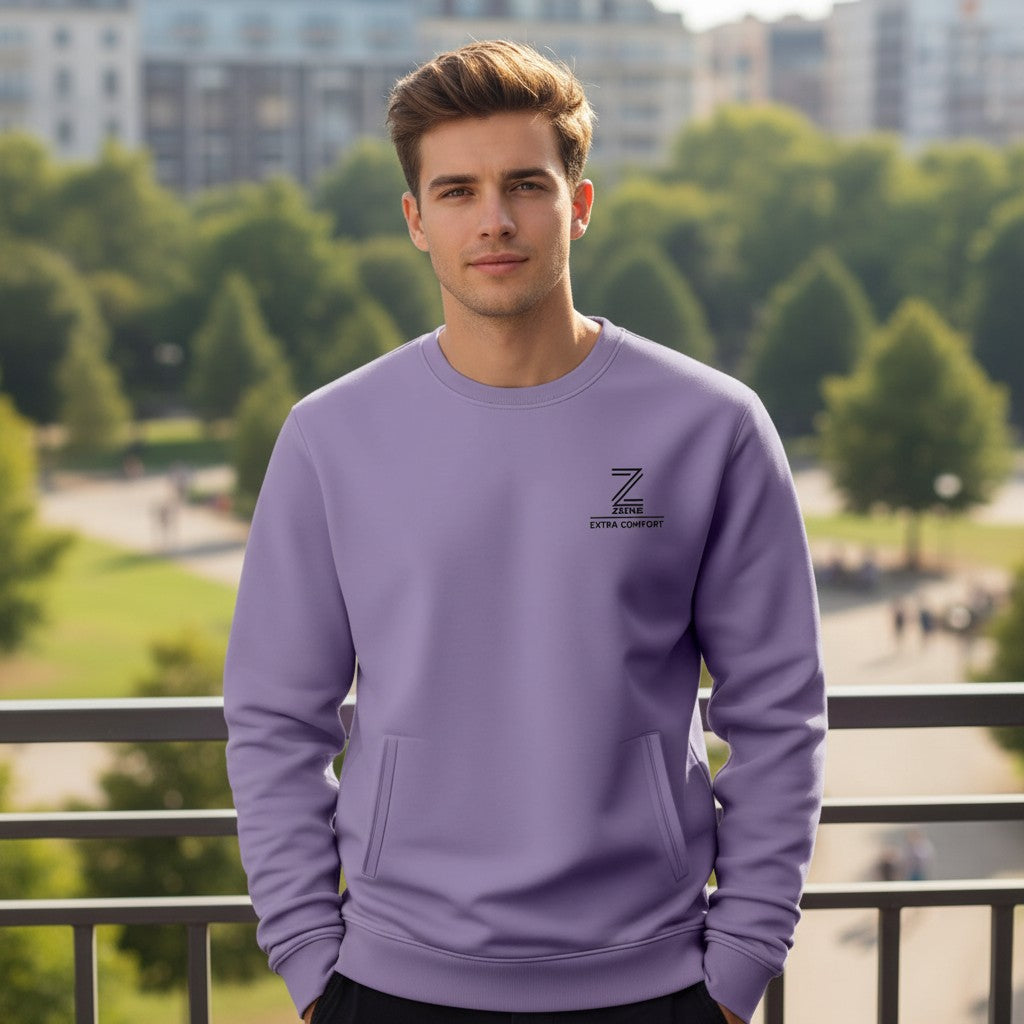 Man wearing a purple sweatshirt with a logo in an outdoor setting