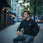 Man sitting on a chair in an urban setting with blurred background