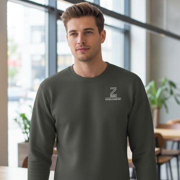 Man wearing a dark gray sweatshirt with a logo in an indoor setting